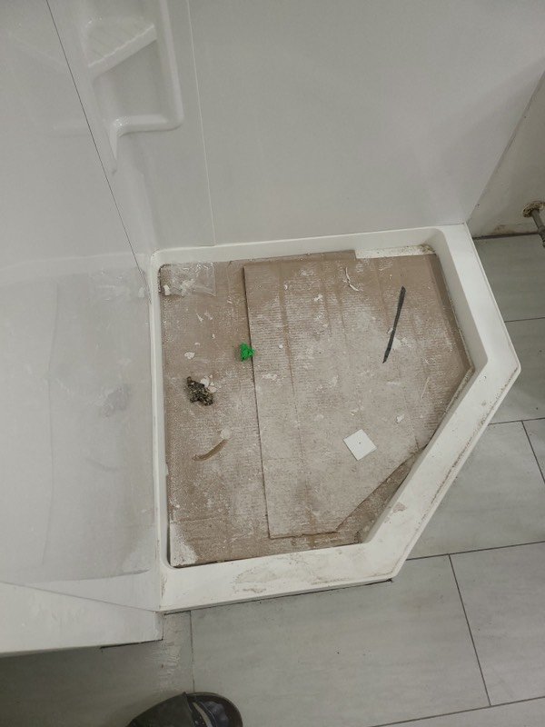 Neo-angle shower base installed and levelled, ready for the surround to be tiled