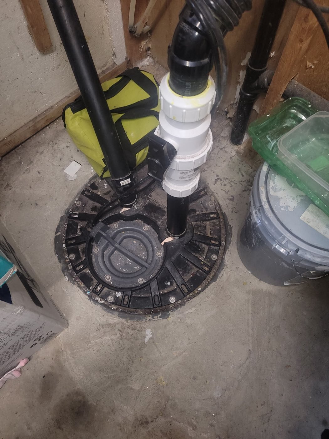 Sealed sump pump pit with discharge piping and a check valve installed in a basement floor